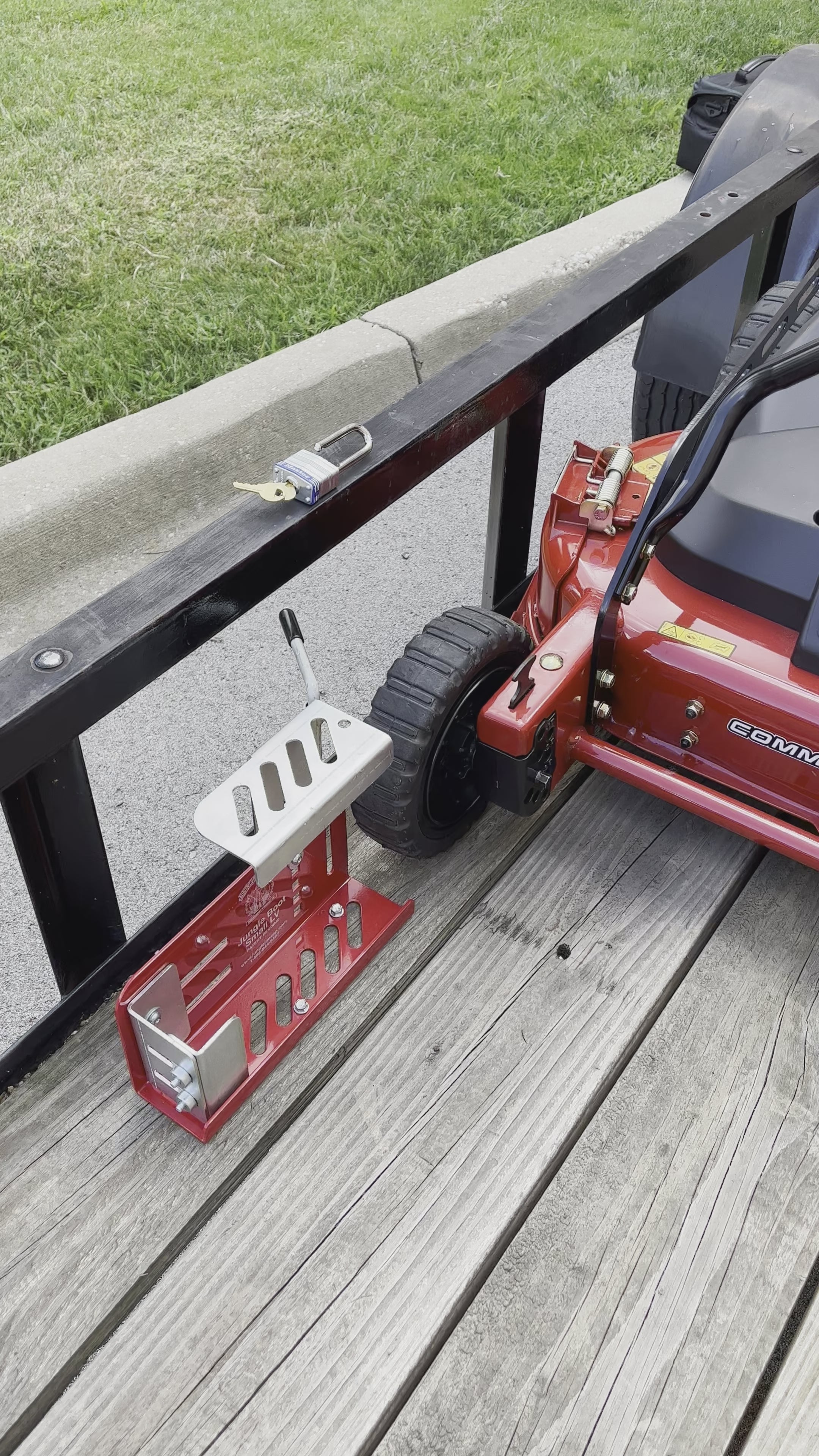 Load video: Jungle Jim&#39;s Jungle Boot Small with Locking Mechanism to Secure Push and Some Commercial Mowers to Lawn and Landscape Trailer