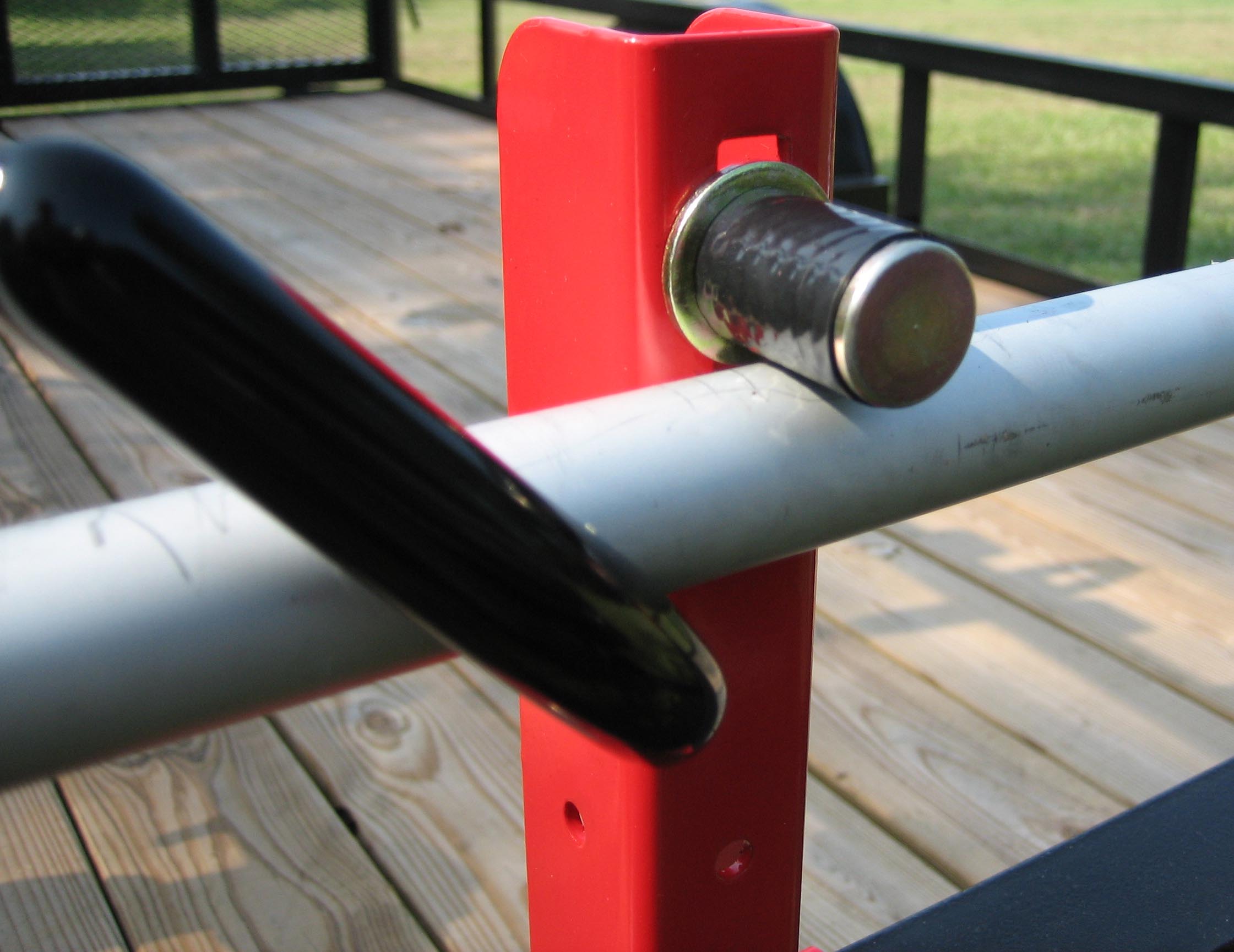 Close-up of the Jungle Jim’s 1TR patented compression pin and locking handle designed to eliminate trimmer rotation and vibration during transport.